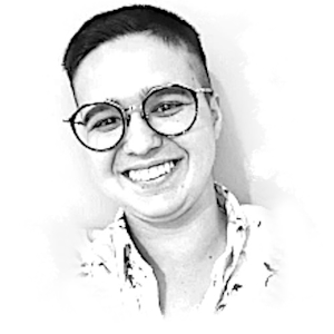 Black and white picture of AJ, a white nonbinary person with short dark hair and glasses. Edited to look like a ripped piece of paper.